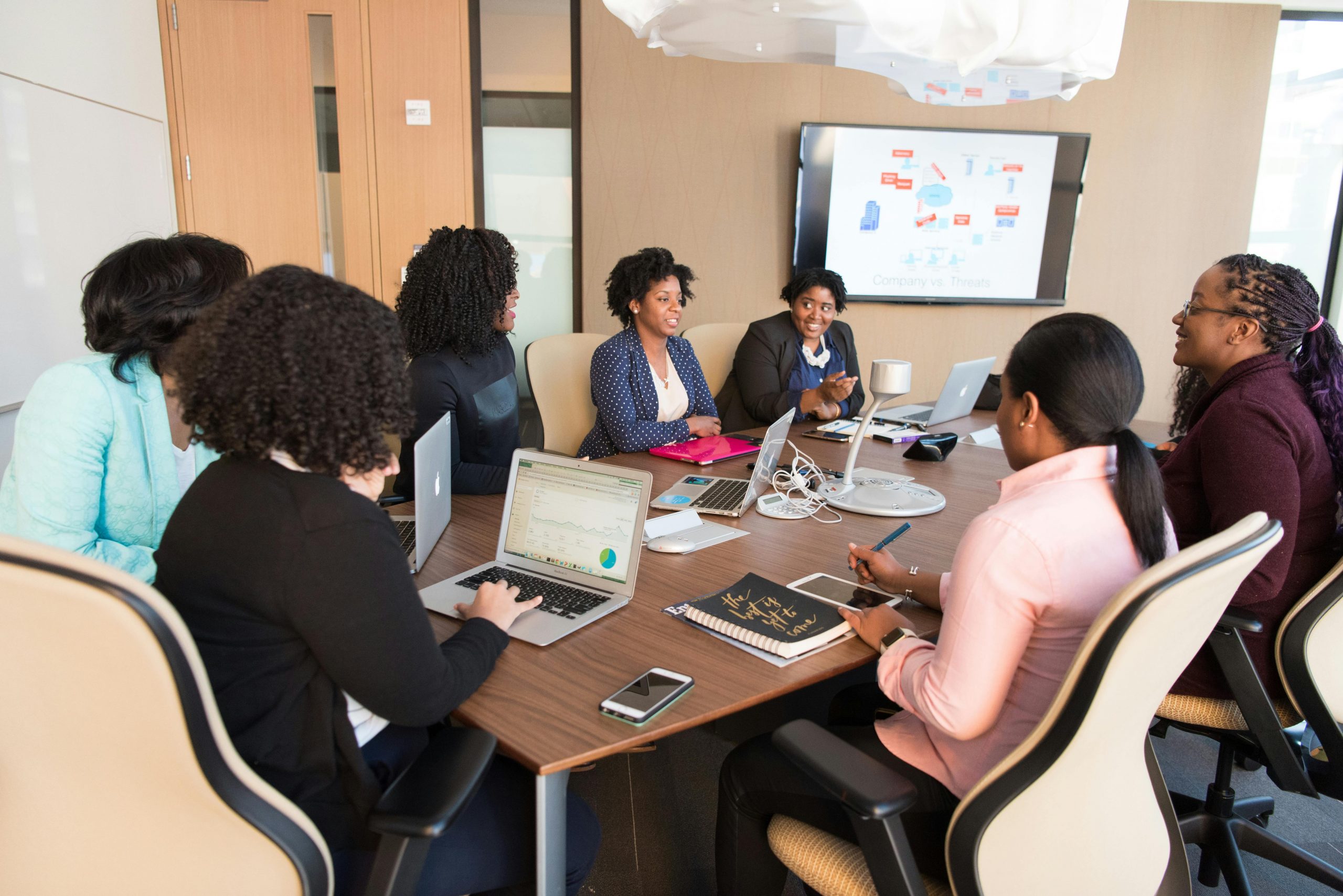 group of professionals in a huddle, discussing a project