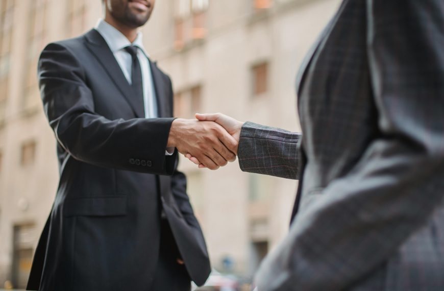 two men in suits shaking hands